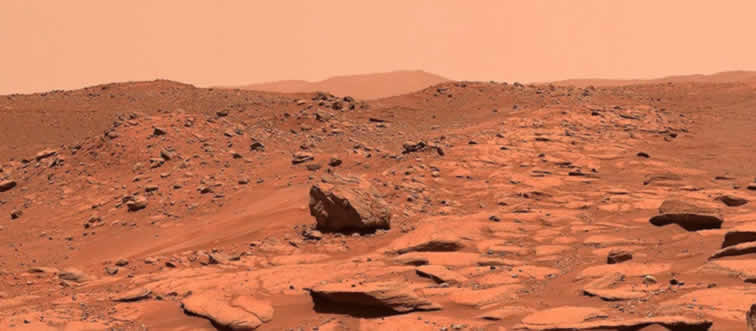 Which celestial neighbor is famously nicknamed the Red Planet?