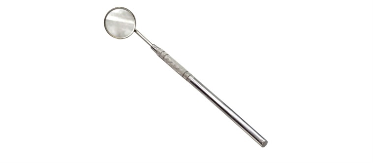 Which tiny, circular reflective tool on a slender wand helps your dentist peek behind your teeth and keeps your tongue from getting in the way?